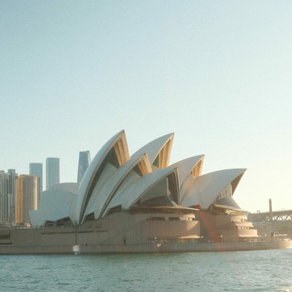 Sydney Opera House viewed from the water during the day, capturing iconic architecture.